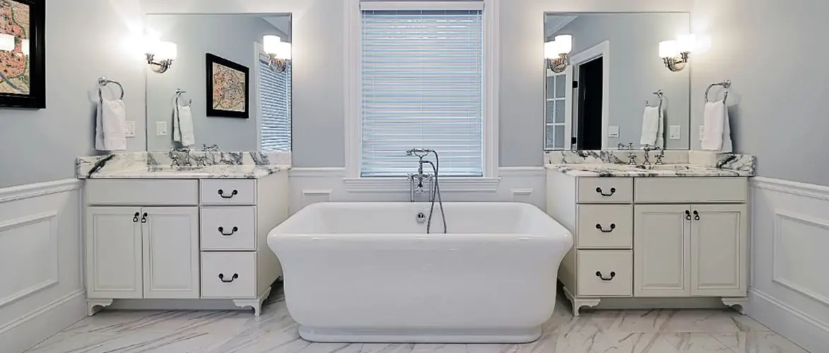 two single vanities separated by bathtub