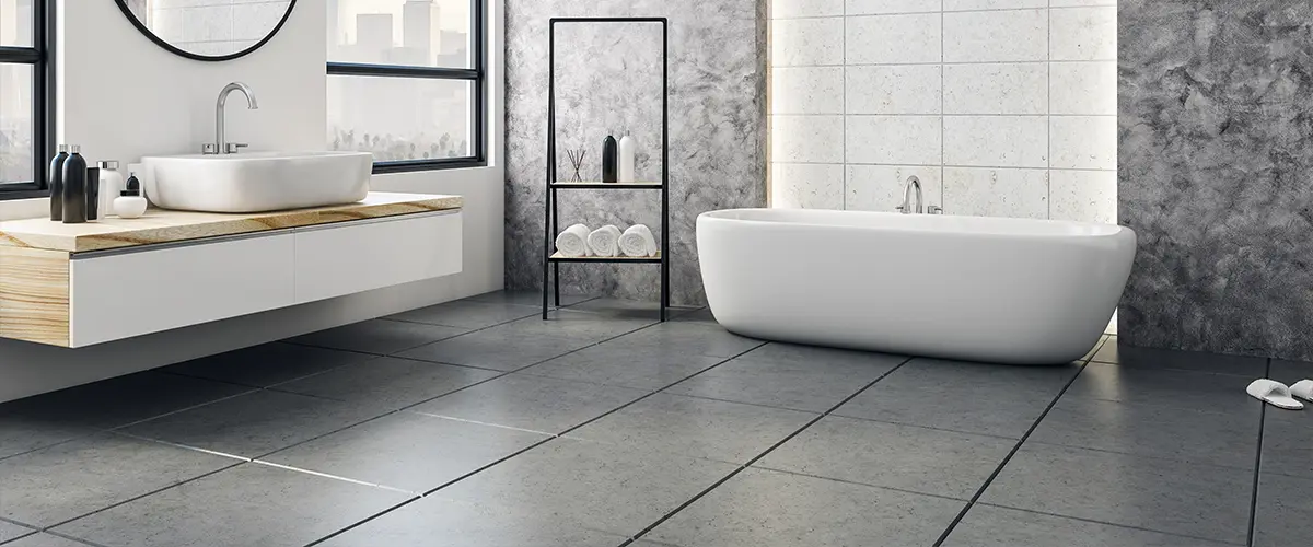 black tile flooring in a bathroom with freestanding tub