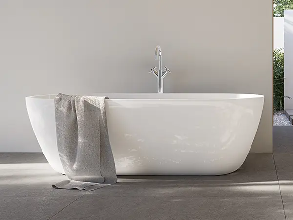 Freestanding tub with a towel hanging on it