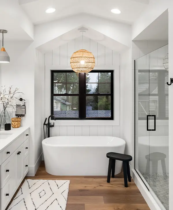 A beautiful bathroom with wood floor and black accents