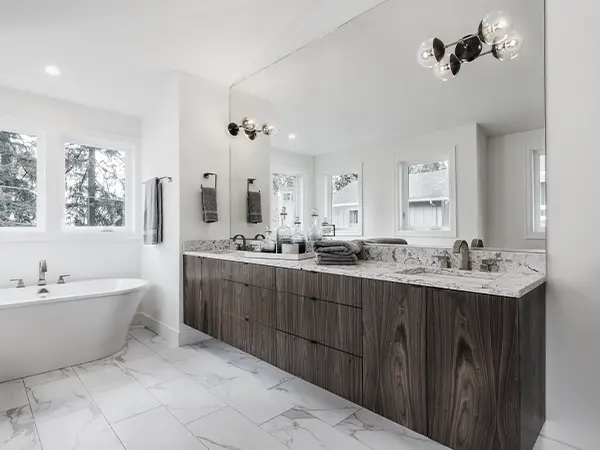 A finished bathroom with a double vanity made of hardwood