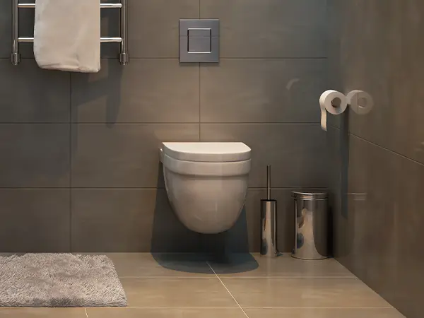 Toilet in bath with large gray tile