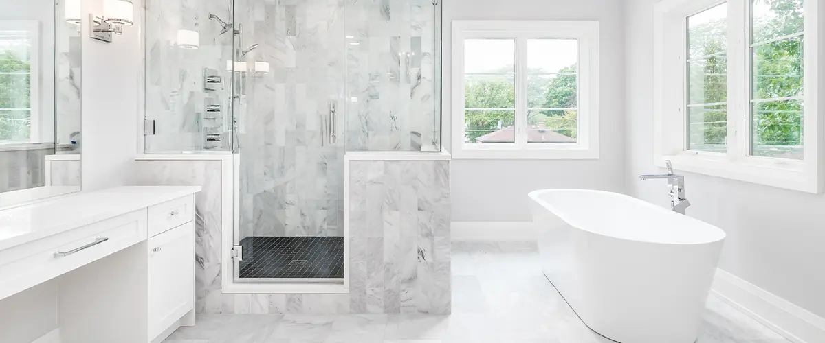 A bathroom addition with a modern and beautiful shower with a freestanding tub