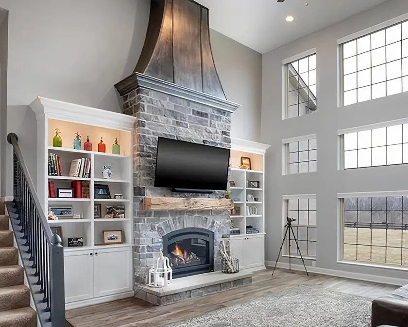 Open high living room remodel in fort wayne with chimney and entertainment area