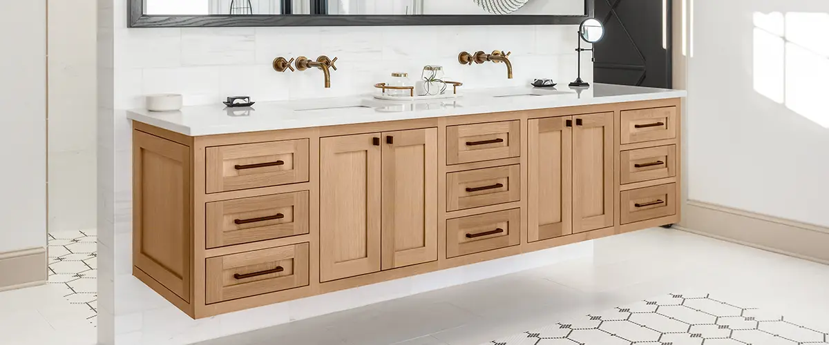 A wood double vanity with black hardware