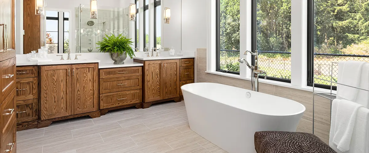 Freestanding tub in a bath with large vanity with beautiful wood grain texture