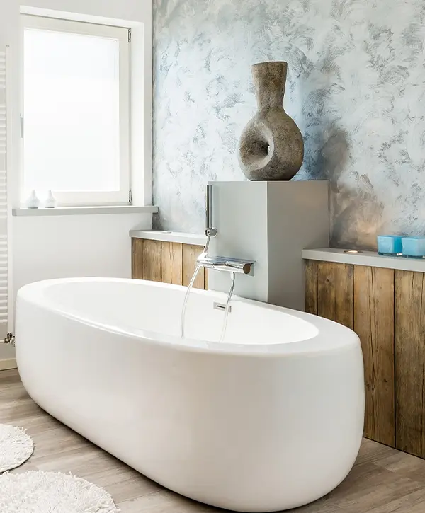A freestanding tub in a bath with ornaments