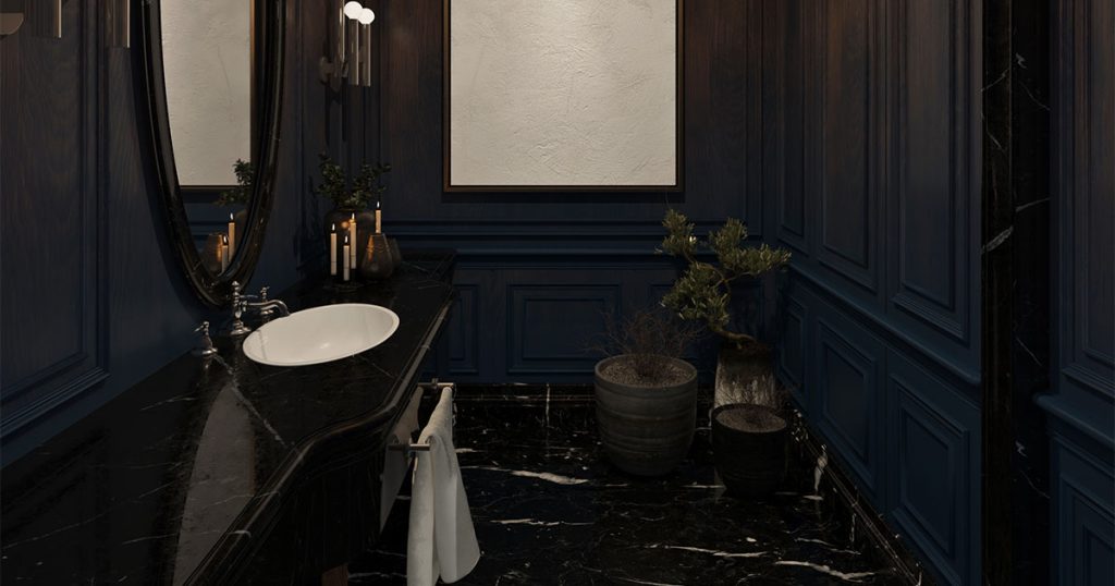 A powder bathroom with black countertop and dark blue walls