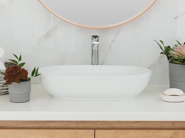 A beautiful vessel sink with a silver faucet
