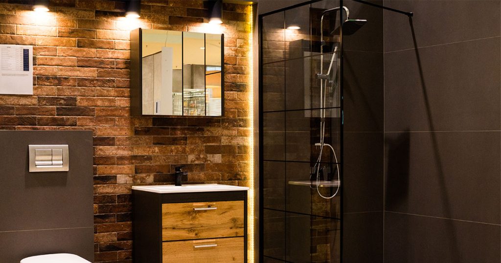 Master bathroom addition with beautiful yellow lights above a small vanity