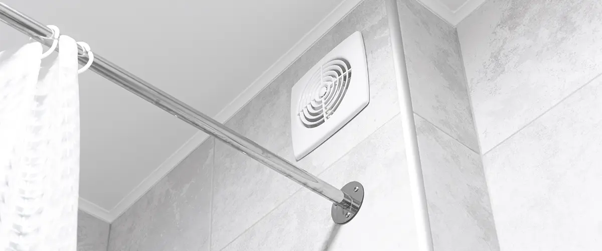 A bathroom vent above a shower-tub combo
