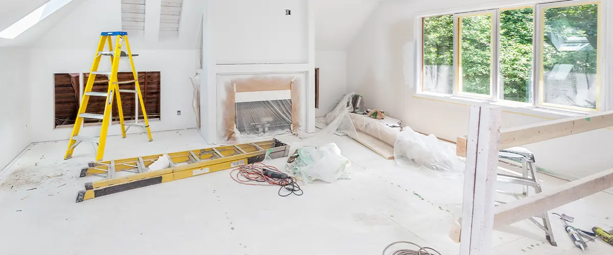 Renovation project in a living space with white subfloor and fireplace