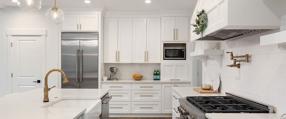 White kitchen cabinets with golden hardware